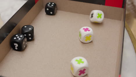 Hand-rolling-gaming-dice-on-a-game-board-in-a-casual-setting-slow-motion