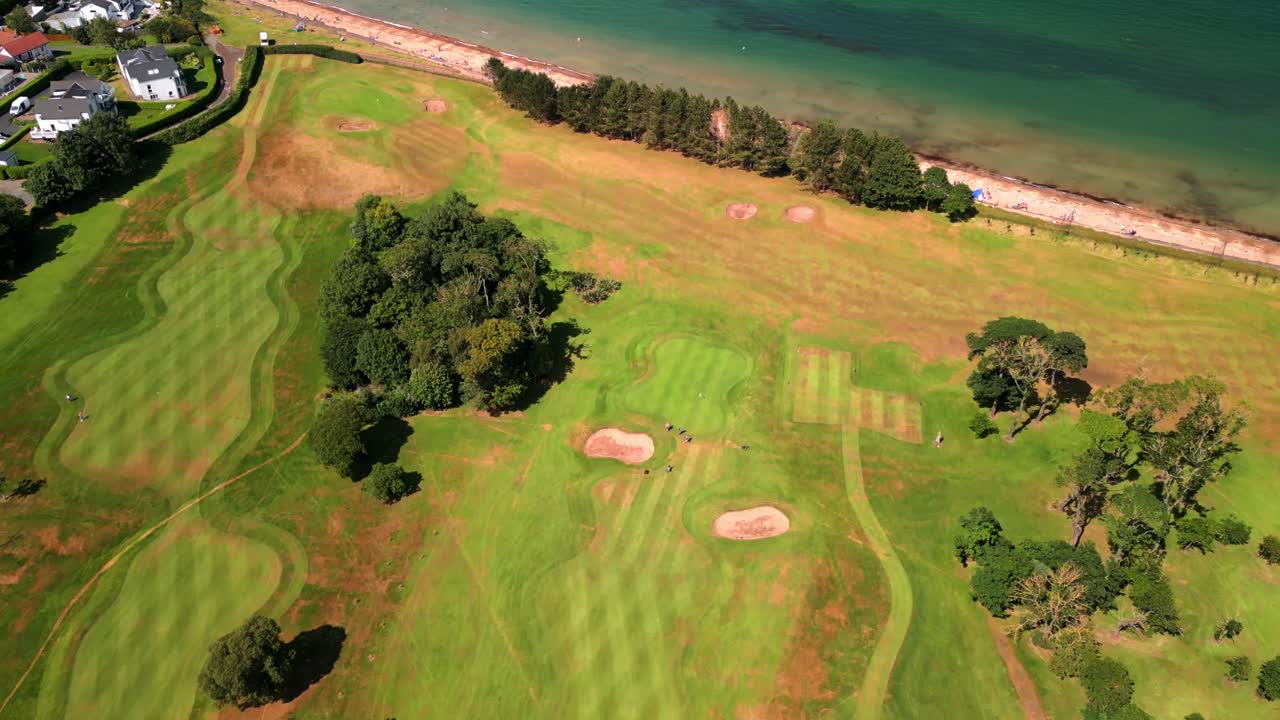4K 30FPS aerial of Helen's Bay Golf Club in County Down, Northern Ireland on a bright summer day. Produced with Rec709 color