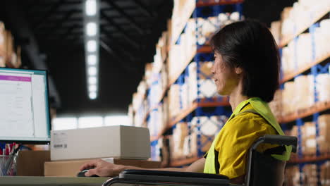 vertical video employee with physical impairment managing warehouse logistics