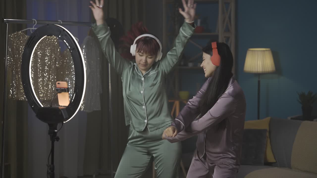 Two Women Dancing in Pajamas at Home