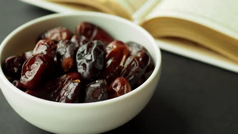 dates in a bowl with a book