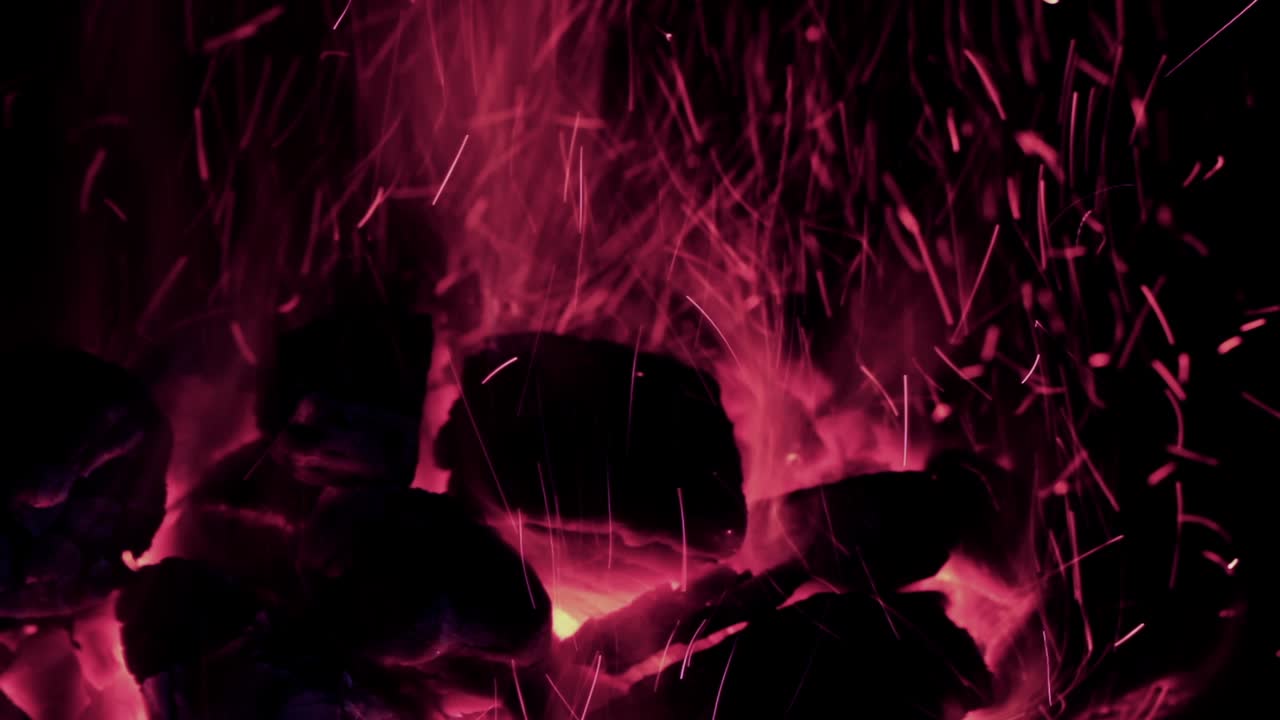 Glowing Red Embers with Flying Sparks in the Dark