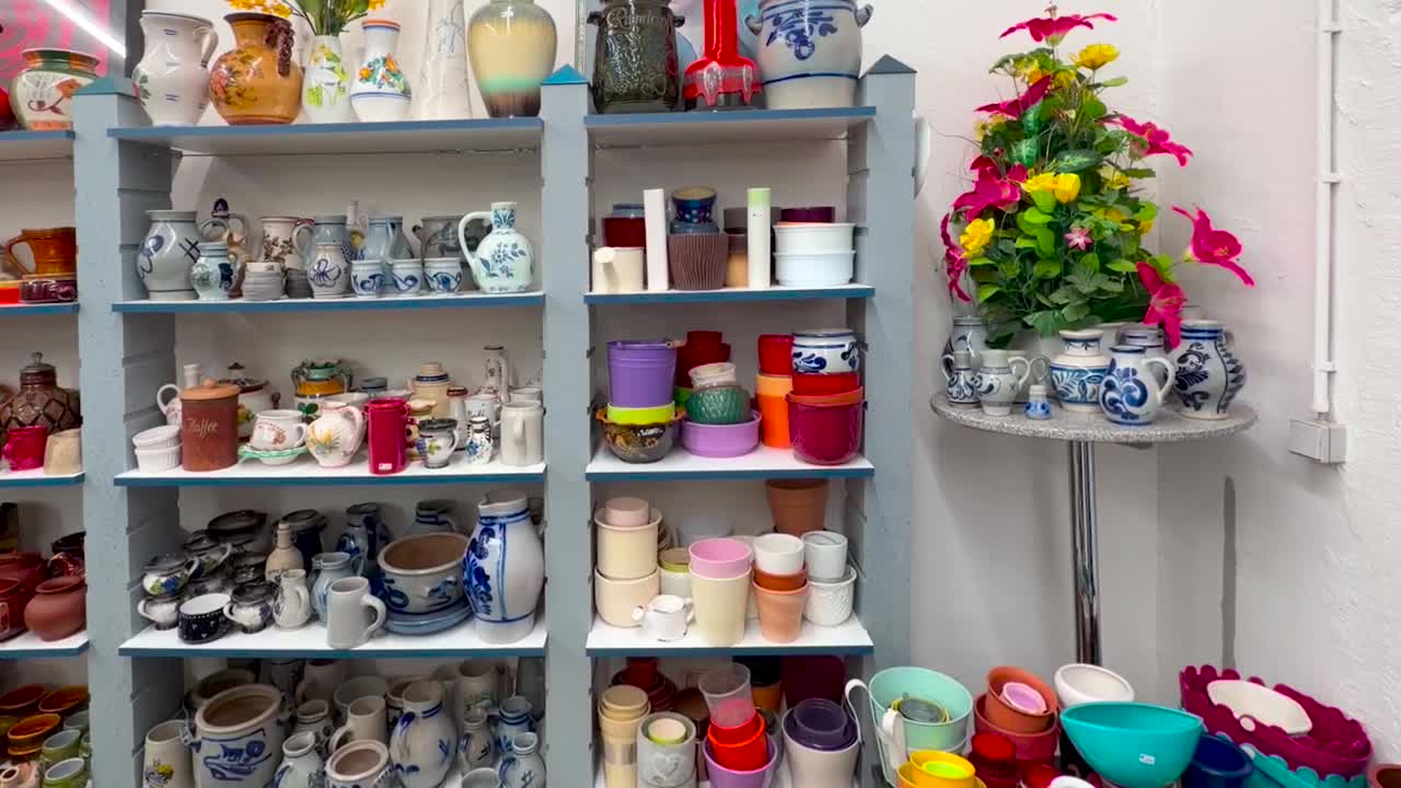 Colorful plastic, ceramic, and glass containers for household use, panning shot