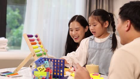 a family engages in educational play with an abacus in a cozy home setting, fostering learning and connection