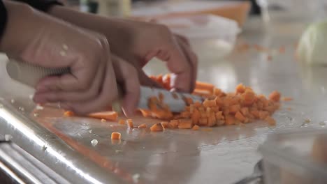 Cook-chopping-vegetables-in-the-kitchen-on-a-table