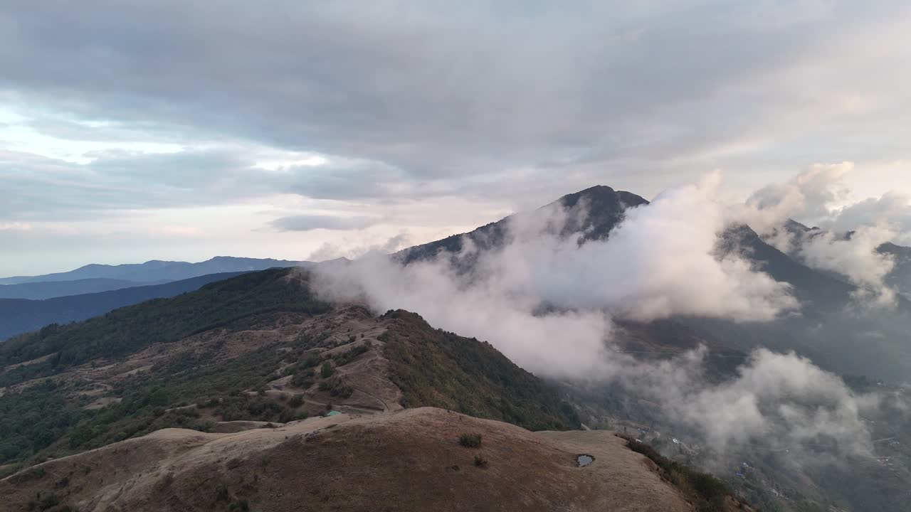 Aerial drone footage of Dhorpatan Hunting Reserve, Nepal, showcasing mist-covered mountains, serene ridges, and tranquil valleys under soft morning light—capturing pure Himalayan wilderness beauty