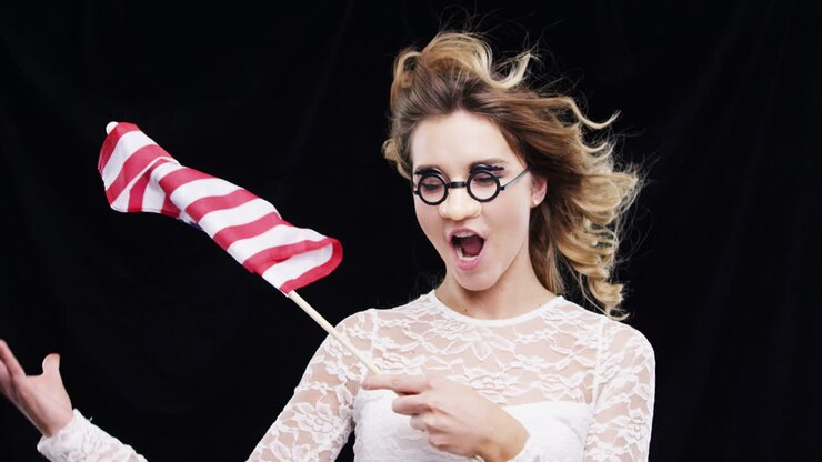 Woman waving American flag independence day celebration slow motion party photo booth