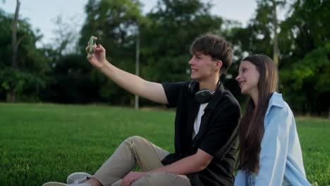 a young couple taking a selfie in a park