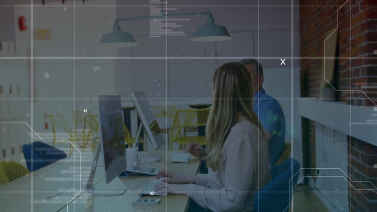 Databehandling over gitterlinjer mod en mand og kvinde, der arbejder på kontoret.