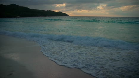 beach in seychelles filmed at twin light after sunset with a beautiful ocean and mountains in the views