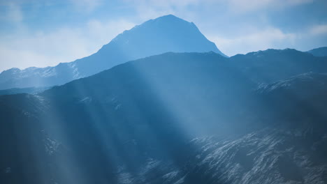 majestic mountain peak rising above misty valleys at dawn