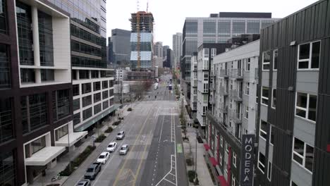 aerial track down a mostly deserted city street, seattle, washington, cloudy