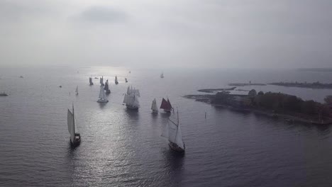 aerial footage of tradtional wooden sailing ships sailing in front of port of helsinki finland