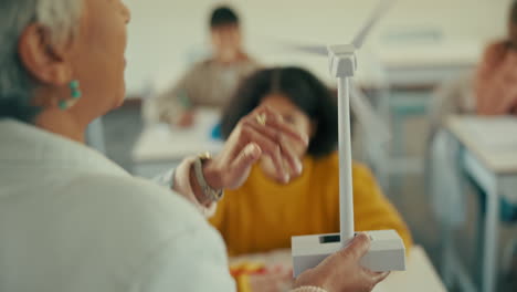 teacher explains wind turbine model to students