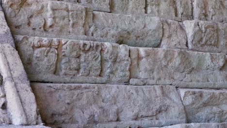 pan across ornate carved pyramid stones at copan mayan ruin, honduras