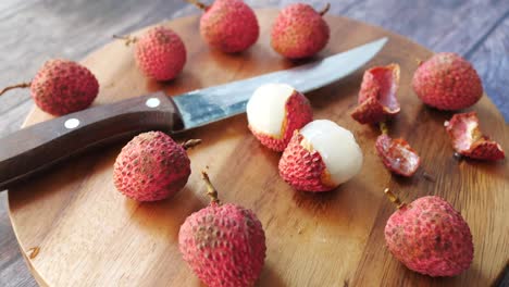 freshly cut lychees on a wooden board