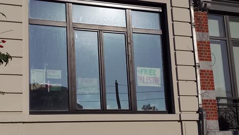 View-of-Free-Palestine-Signs-on-Window-in-Brussels,-Belgium