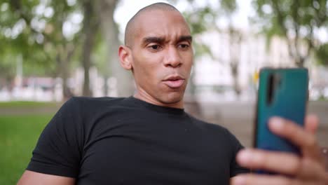positive man talking by video call on phone and agrees