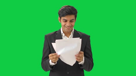 Happy-Indian-businessman-reading-the-contract-Green-screen