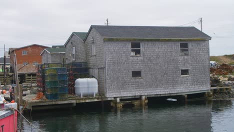 a fisherman's home on the shore with lobster traps