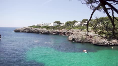 slow motion: tilt down to crystal clear sea of mallorca island, spain