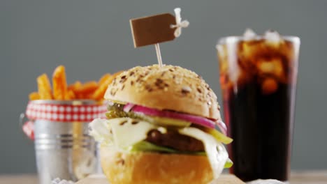 Hamburger,-french-fries-and-cold-drink-on-table