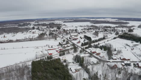 red barns stand out on white winter landscape in rural location with blanket of new white snow on the ground