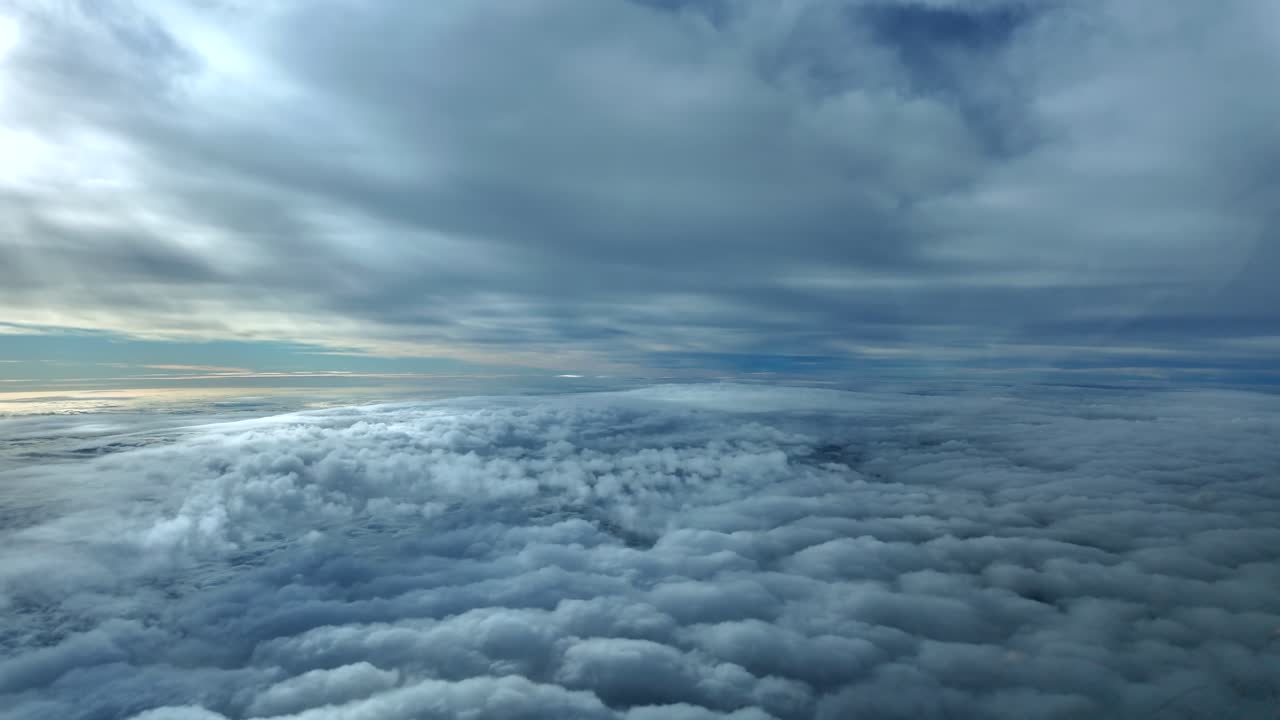 Pilot’s eye view flying through a serene and cold winter sky, covered by low altitude snow clouds