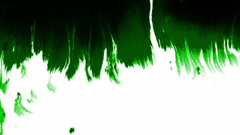 Splashes-and-spots-of-green-ink-spreading-on-white-background