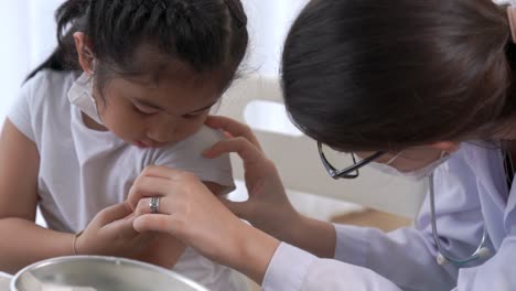 school girl visits skillful doctor at hospital for vaccination