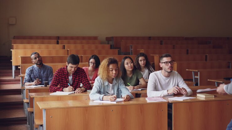 Students in a classroom taking notes during a lecture