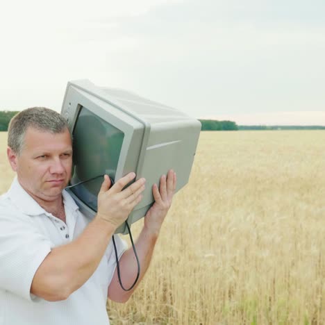 A-Cool-Middle-Aged-Man-Carries-An-Old-Tv-Set-On-His-Shoulder-1