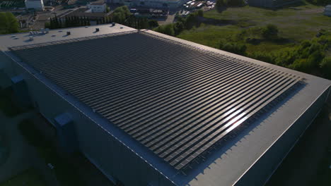 sun reflecting off a large array of solar panels on top of a building