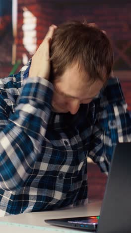 Vertical video Exhausted freelancer feeling overworked while typing on device keyboard