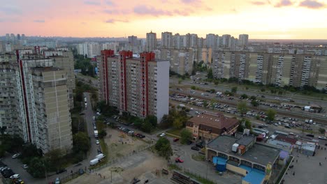 Aerial-view-in-front-of-old-soviet-made-apartment-buildings,-in-a-indigent-slum-neighborhood-of-Kyiv,-during-sunset,-in-Kiev,-Ukraine---rising,-drone-shot