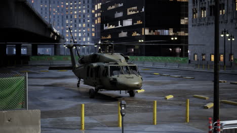 military helicopter in city parking lot at night