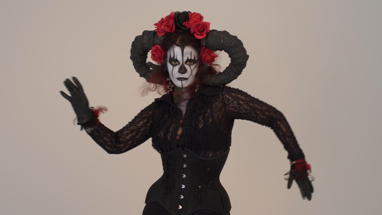 Woman in a Dark Fantasy Costume with Horns and Roses