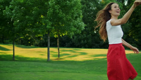 woman and boy running in meadow with ball. mother and son playing with ball