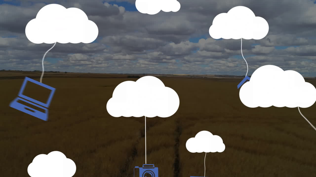 Floating cloud icons with technology symbols over rural landscape under cloudy sky