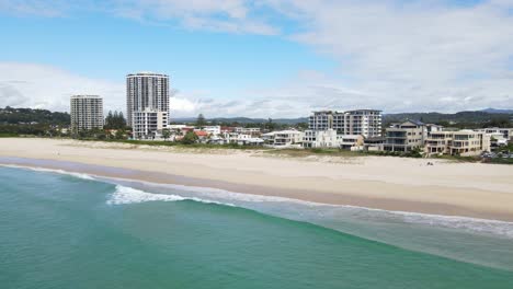 building structures at the oceanfront and the blue water of palm beach in the city of gold coast, queensland, australia