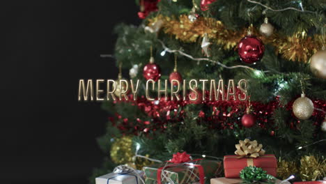 merry christmas text over decorated christmas tree and gifts on black background