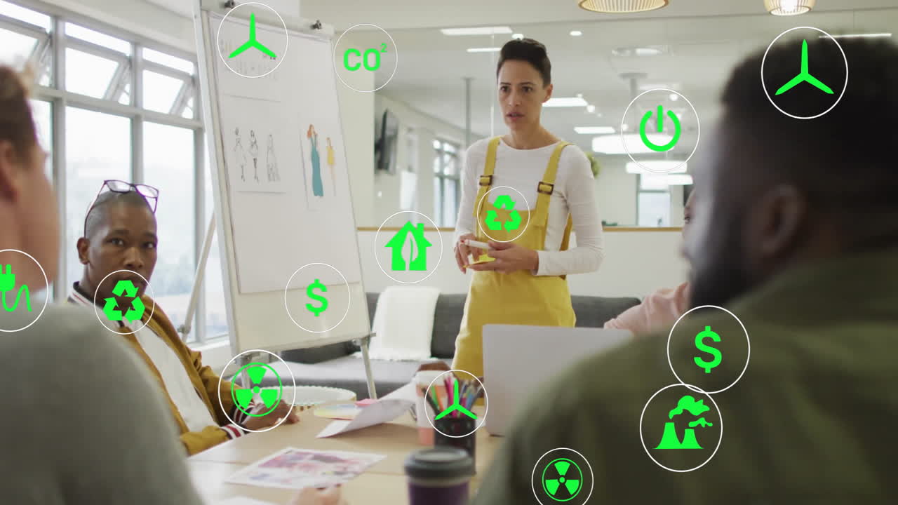 Green sustainability icons animation over diverse business team in meeting