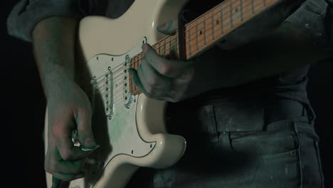 guitar getting hit with green powder at 1000fps in super slow motion