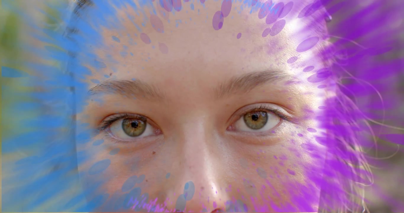 woman opening eyes in forest as digital purple blue paint splashes rotating inward in tech demo