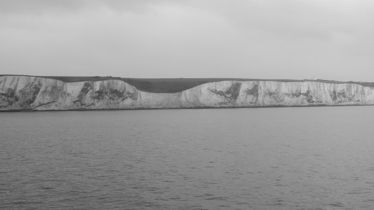 Panning shot of White Cliffs of Dover that is a part of the English channel facing the strait of Dover in South England on a foggy morning
