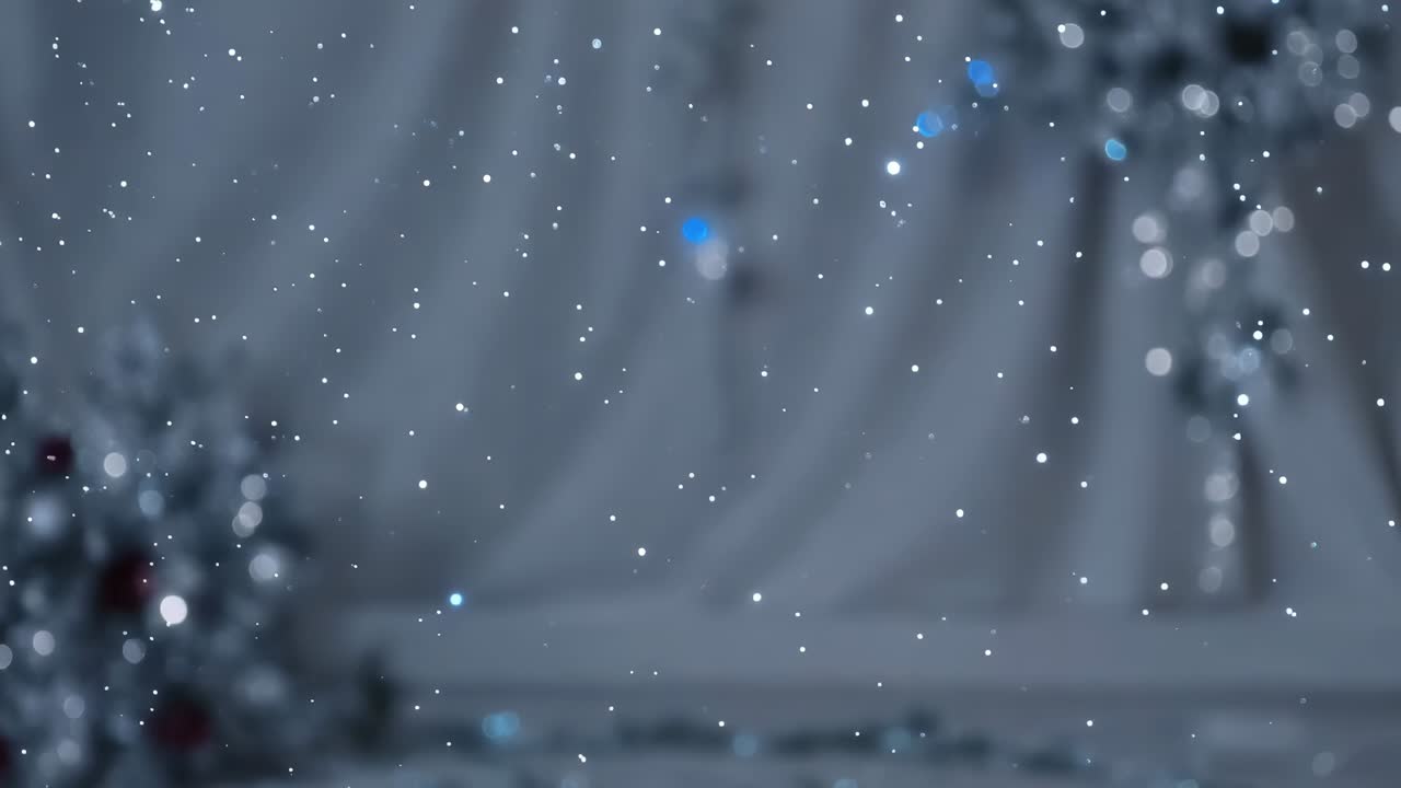Playback starting, falling white particles drifting across draped backdrop to create holiday mood