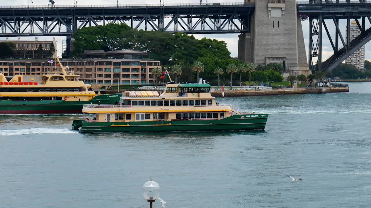 A Sydney Ferry glides across the harbor, offering stunning views of the iconic skyline and landmarks, providing a unique and scenic travel experience.