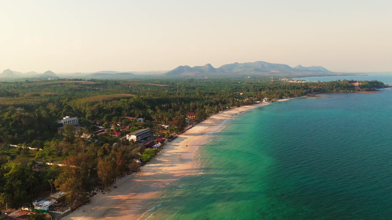 Aerial of Chumphon, Thailand, stunning coastline, turquoise waters, and tropical islands with long tree shadows stretching into water