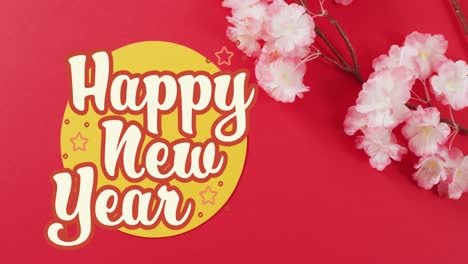 Animation-of-new-year-greetings-text-over-chinese-traditional-decorations-on-red-background