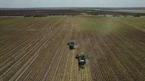 aerial - combine harvester cultivating land, agriculture field, mexico, forward shot